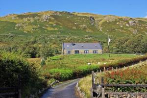 a house on the side of a hill with a road at 6 Bed in Clonbur oc-i275 in Finny