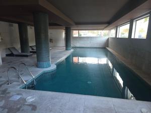 a large swimming pool in a building at Foz Palace - Praia da Rocha in Portimão