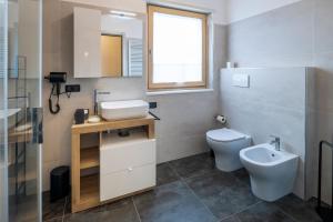 a bathroom with a sink and a toilet at - Magenta Apartment - in Monfalcone