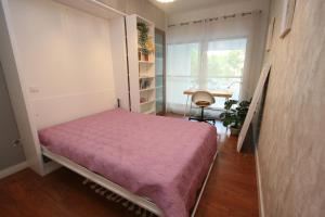 a bedroom with a bed in a room with a window at Foz Palace - Praia da Rocha in Portimão +22 photos
