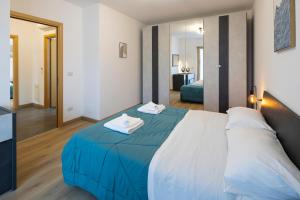 a bedroom with a large bed and a mirror at - Magenta Apartment - in Monfalcone +15 photos