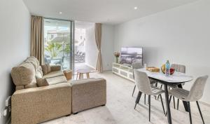 a living room with a couch and a table at MSV Beach in Puerto Naos +4 photos