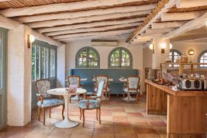 a dining room with a table and chairs at Petit Hotel Ses Rotges - Only Adults in Cala Ratjada