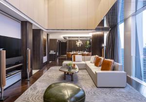 a living room with a couch and a table at Conrad Hangzhou in Hangzhou
