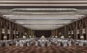a large banquet hall with white tables and chairs at Conrad Hangzhou in Hangzhou