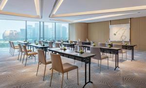 a conference room with tables and chairs and windows at Conrad Hangzhou in Hangzhou +64 photos
