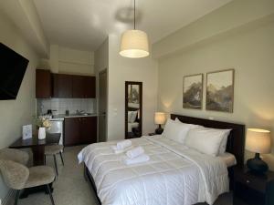 a bedroom with a large bed with two towels on it at Ξενώνας Λίθος in Kato Loutraki