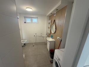 a bathroom with a toilet and a sink and a mirror at Kwatera pracownicza Leszno in Leszno +18 photos