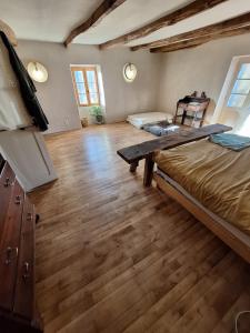 a room with a bed and a wooden floor at Gîte Léon, Beynat, Corrèze in Beynat