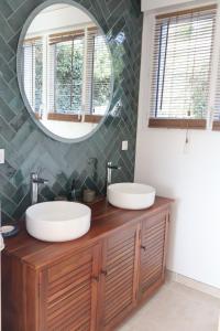 a bathroom with two sinks and a mirror at La parenthèse de la Bouvaque in Abbeville