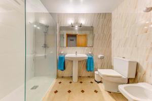 a bathroom with a toilet and a sink and a shower at Emma Beachfront Apartment by Sealand Villas in Port de Pollensa +17 photos
