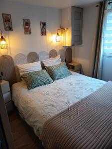 a bed in a bedroom with two pillows on it at Mobile home in Quimper