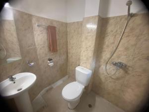 a bathroom with a toilet and a shower and a sink at Only Adults- RAI in Golden Sands +15 photos