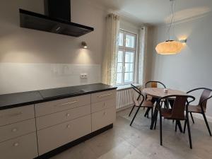 a kitchen with a table and a dining room at Apartament Kirkor przy Dworku Bielin in Bielin