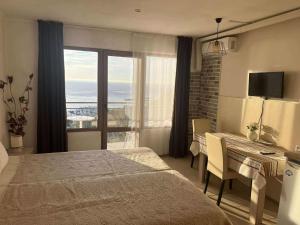 a bedroom with a bed and a desk and a window at Only Adults- RAI in Golden Sands