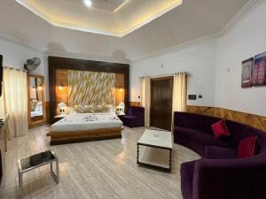 a living room with a bed and a couch at MJ Funcity Water Park & Resort in Lucknow