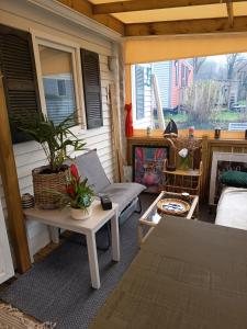 a screened in porch with a couch and a table at Mobile home in Quimper