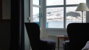 two chairs and a table in front of a window at Marina Hotel Sortland in Sortland
