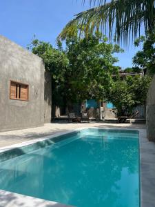 a swimming pool in front of a house at CASA JASMIM, vila florescer, centro histórico!! in Piranhas