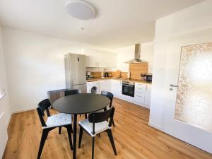 a kitchen and dining room with a table and chairs at Modern Apartment Wissenbach 1 in Eschenburg