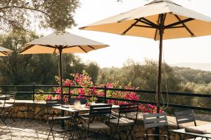 a patio with tables and umbrellas and flowers at Finca Serena Mallorca, Small Luxury Hotels in Montuiri +43 photos