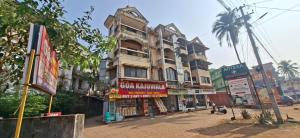 an old building on a city street with shops at Casa de Aaron in Colva