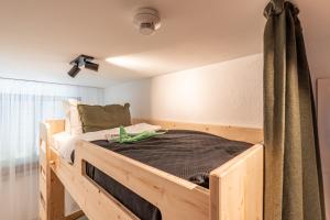 a bedroom with a wooden bed in a room at stuub jostal in Titisee-Neustadt
