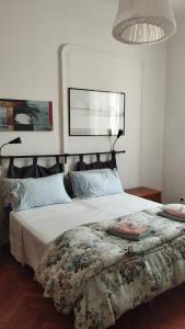 a bedroom with a large bed with a blanket at B&B Piazza Goldoni in Trieste