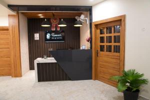 a restaurant with a bar with a sign on the wall at Konwar Inn & Suites in Golāghāt