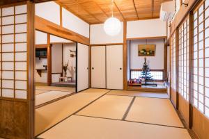 a japanese room with a christmas tree in the window at Mountain Home - One Hour From Osaka in Uda