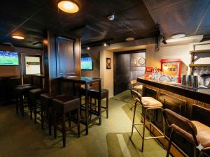 a bar with brown stools in a room at Hotelli Savonlinna in Savonlinna +26 photos