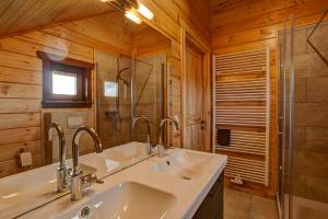 a bathroom with two sinks and a glass shower at Ecolodge Sauerland 2 in Medebach +58 photos