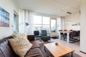 a living room with a couch and a table at Vleijenhof Type C in Buren