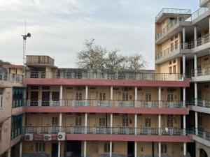 an apartment building with a balcony on top of it at Qaiser Hotel in Lahore