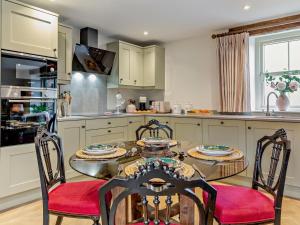 a kitchen with a table and chairs in a kitchen at 2 Bed in Carlisle oc-96302 in Scaleby