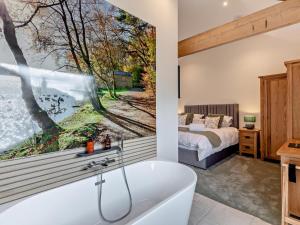 a bathroom with a bath tub next to a bedroom at 2 Bed in Carlisle oc-96302 in Scaleby