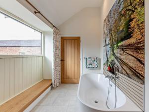 a bath tub in a bathroom with a large window at 2 Bed in Carlisle oc-96302 in Scaleby +32 photos
