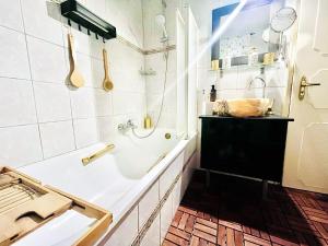 a white bathroom with a tub and a sink at Nirvana Apartman in Balatonberény +29 photos