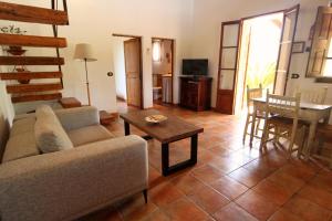 a living room with a couch and a table at Villa Roqueta by Sealand Villas in Pollença +10 photos