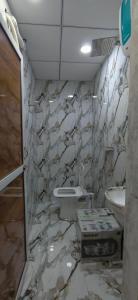 a marble bathroom with a toilet and a sink at Hotel Heritage Prime Junagadh in Junagadh +97 photos