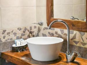 a white bowl sink on a counter in a bathroom at Posada Quellen in Villa General Belgrano +53 photos
