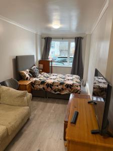 a living room with two beds and a couch at Bel City in Thornton Heath