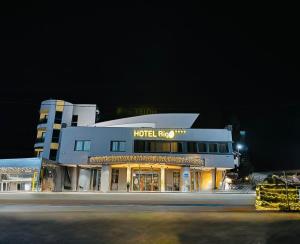 a hotel building at night with a street in front at Hotel Biga in Zavidovići