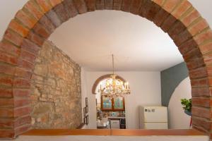 an archway in a kitchen with a brick wall at Valdichiana Panorama Villa - Private Pool in Marciano
