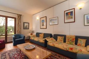 a living room with a couch and a coffee table at Valdichiana Panorama Villa - Private Pool in Marciano