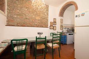 a kitchen with a table and chairs and a refrigerator at Valdichiana Panorama Villa - Private Pool in Marciano +20 photos
