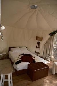 a bedroom with a bed in a tent at Kabaceira Glamping in Atalaia +65 photos