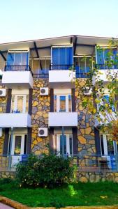 a tall building with balconies on the side of it at Haluk Otel in Milas