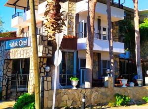 a building with a street sign in front of it at Haluk Otel in Milas