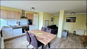 a kitchen and dining room with a wooden table at Seeblick in Hohenfelde